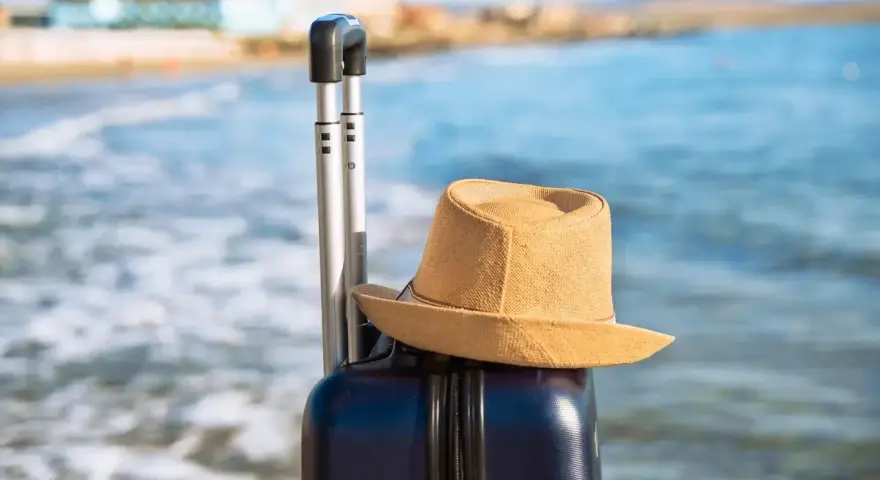 Walizka i kapelusz na plaży. Idealna pogoda w Bułgarii w październiku na ostatnie chwile lata.